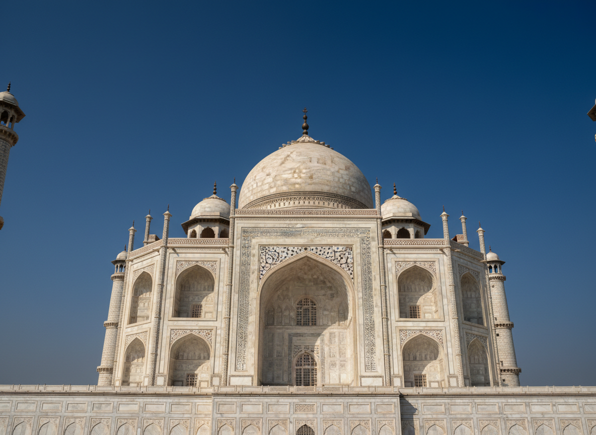 Taj Mahal dome and minarets against blue sky
