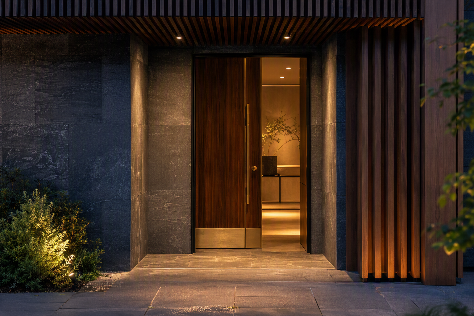 Premium Melbourne building entrance at dusk with brushed brass door hardware catching low light