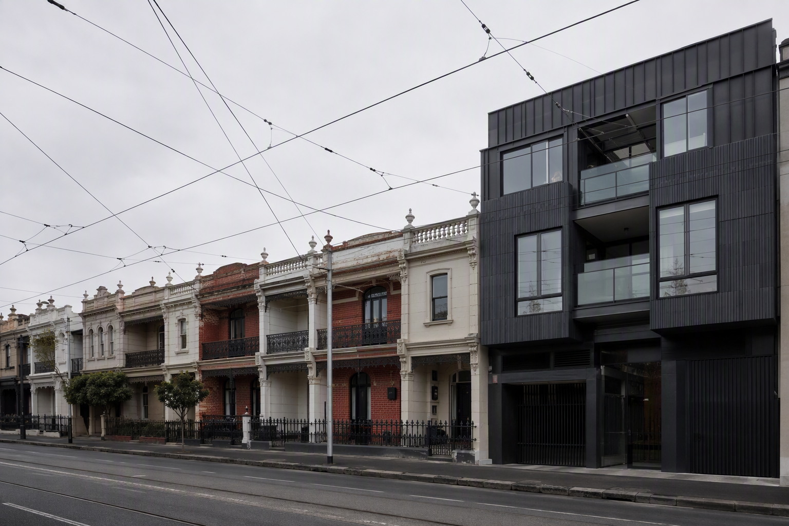 North Melbourne streetscape with Victorian terraces beside a contemporary apartment building
