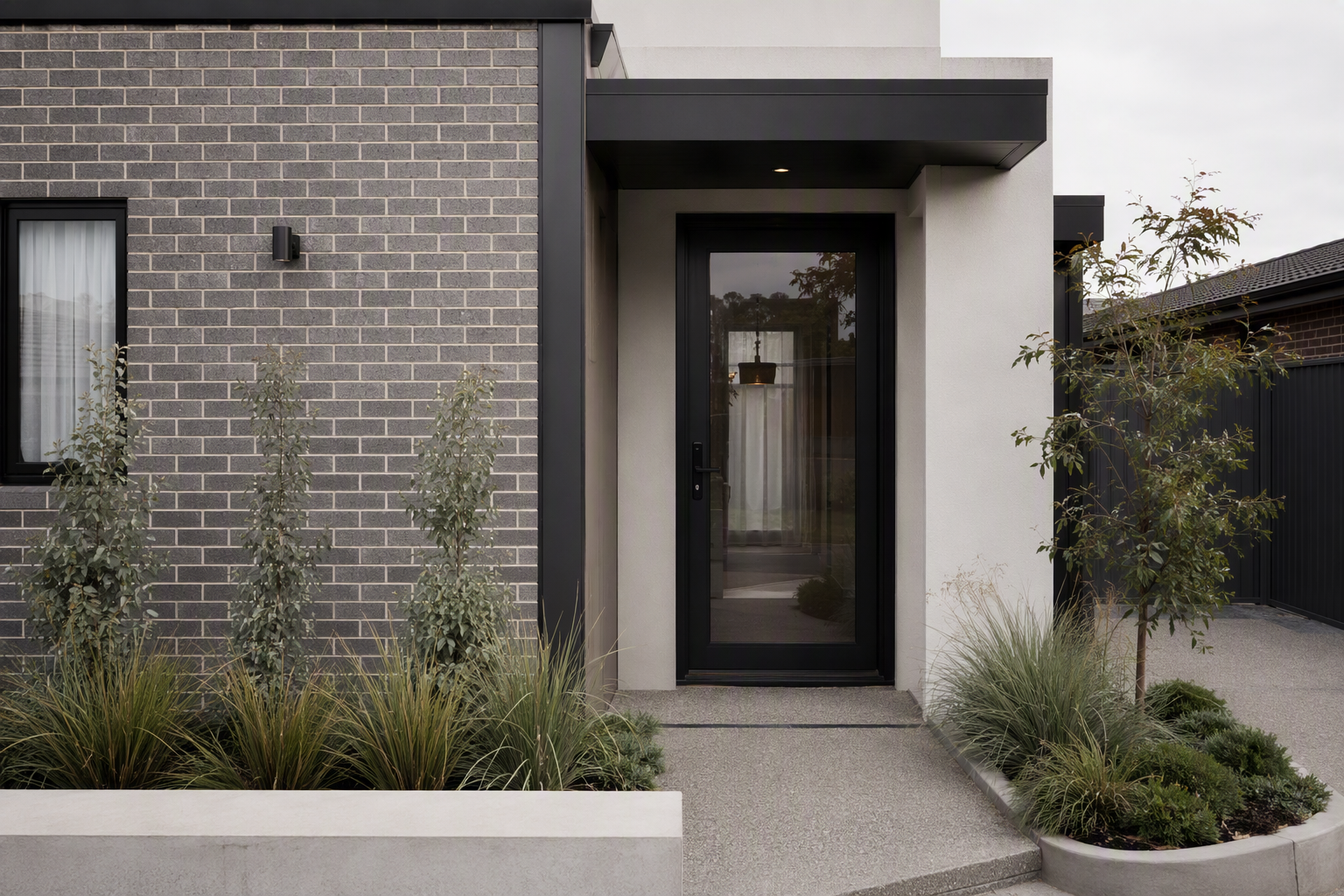 Entrance of a contemporary Melbourne townhouse with a modern lever-handle front door