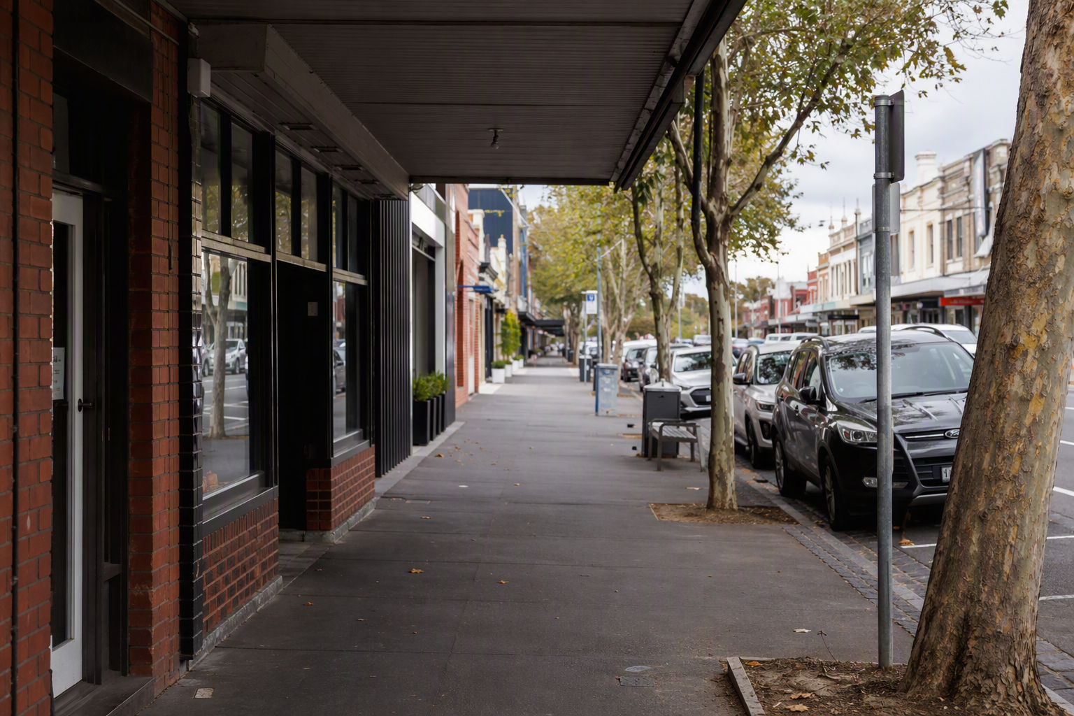 Suburban eastern Melbourne retail street in Ringwood with brick shopfronts, glass doors and an overhead verandah