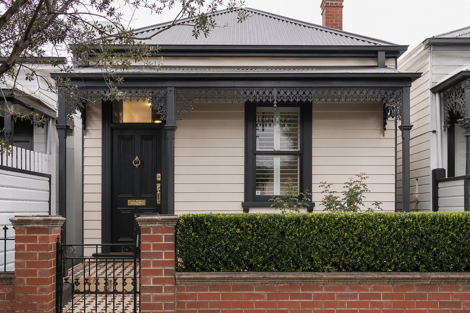 Front elevation of a single-fronted weatherboard Melbourne house with a dark timber front door