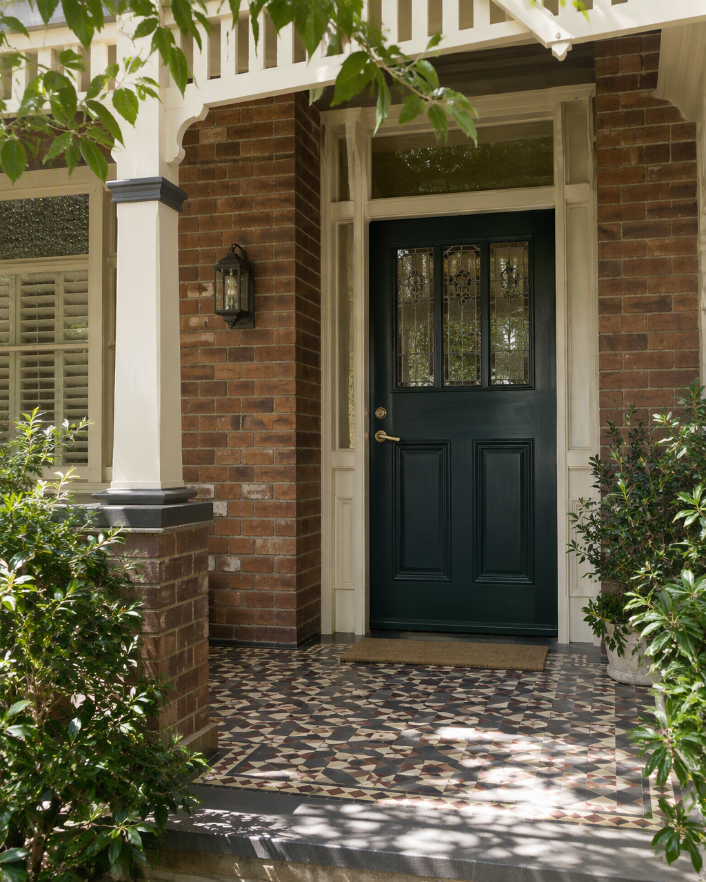 Period Sydney house entry with a petrol-green timber door and brass lever handle