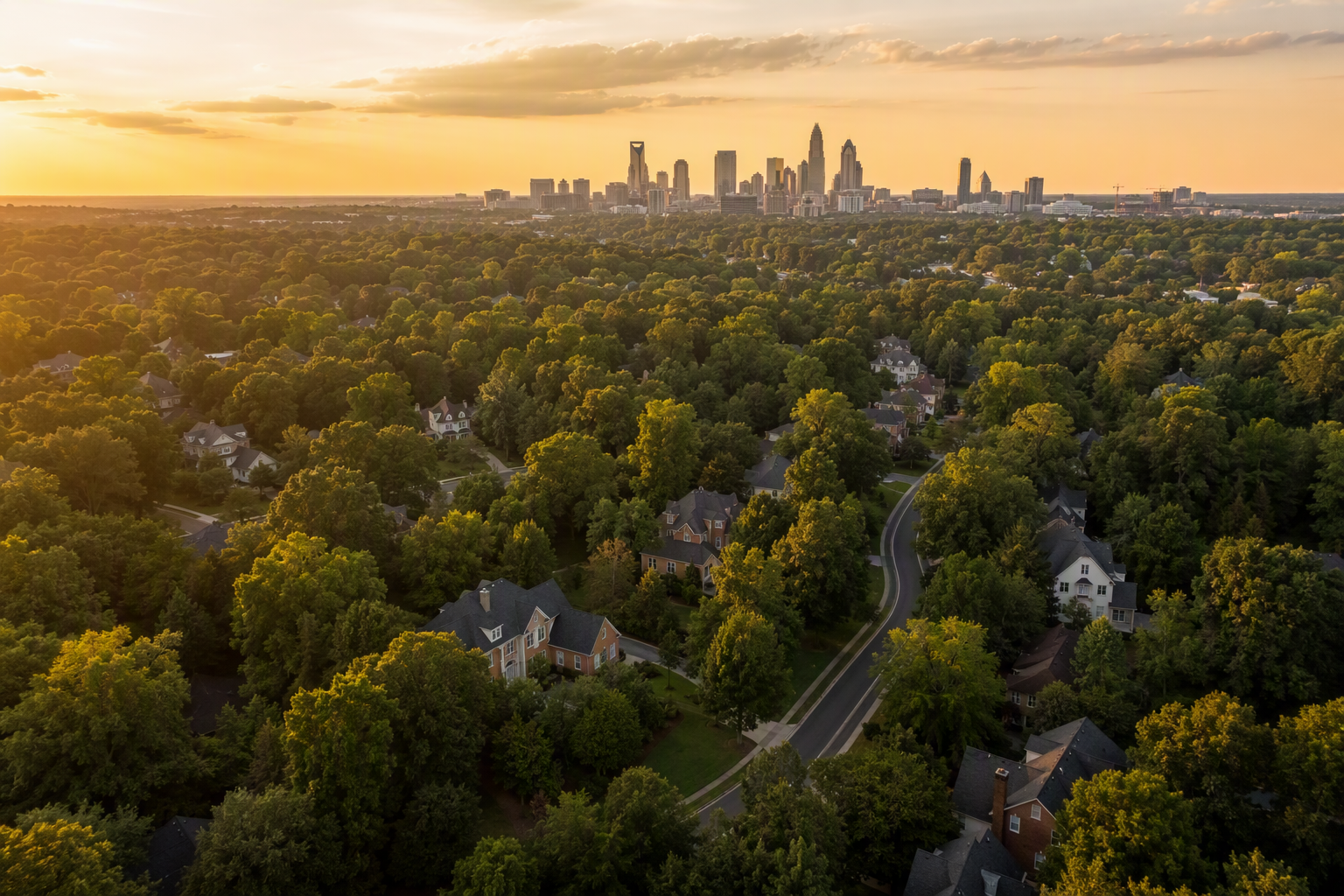 Aerial view of Charlotte-area neighborhoods with the skyline on the horizon