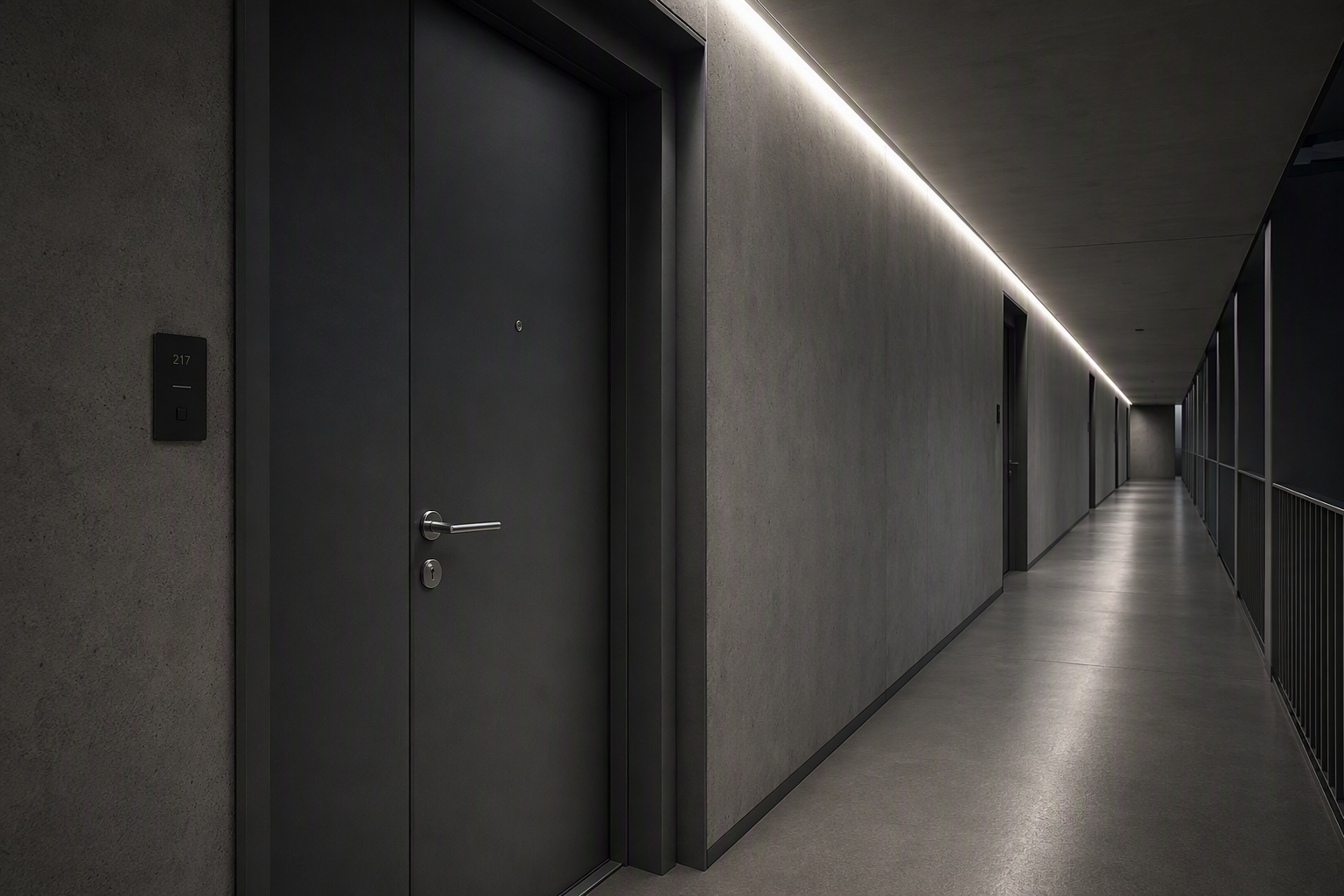 Quiet apartment building corridor at night with a single closed door and linear ceiling lighting