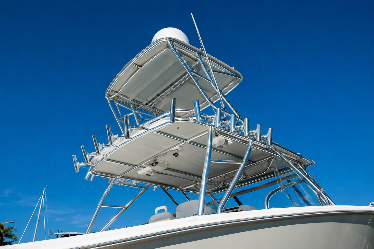 Custom welded aluminum T-top and tuna tower with rod holders and a radar dome on a center console boat