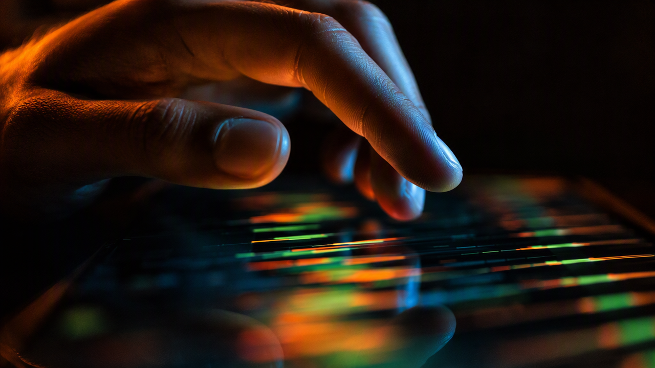 A hand hovering over a phone showing rapidly changing live odds with motion blur